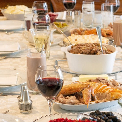 image of a table set for a bit lunch with wine